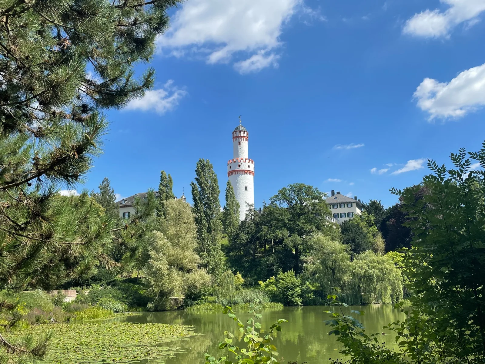 White Tower rising above trees and water near Bad Homburg Palace Park