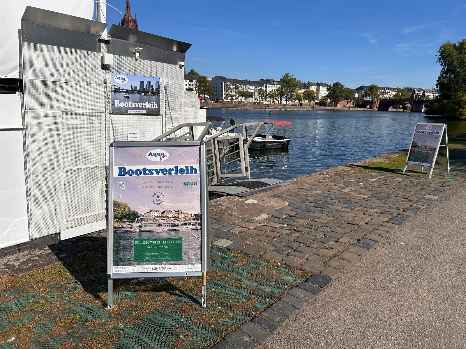 Aqua Fun electric-boat rental sign and jetty on the Sachsenhausen bank
