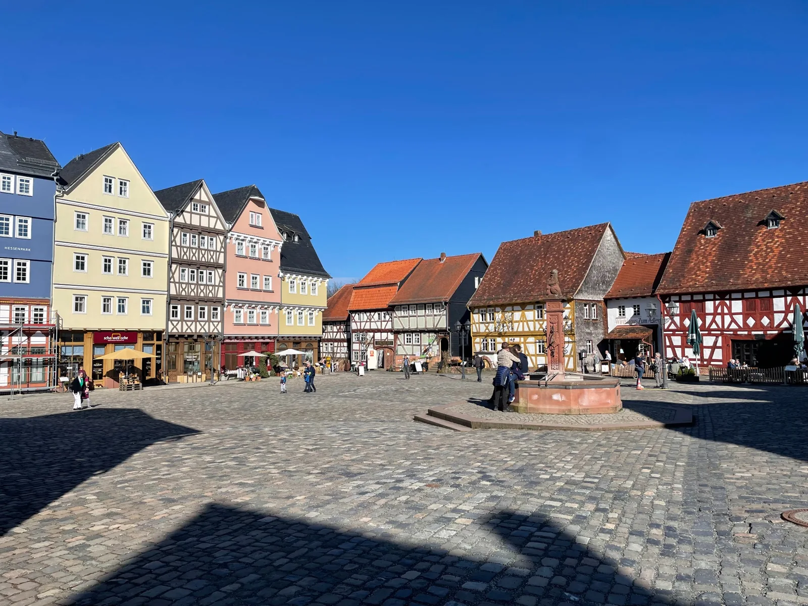 The market square at Hessenpark with timber-framed buildings and a fountain