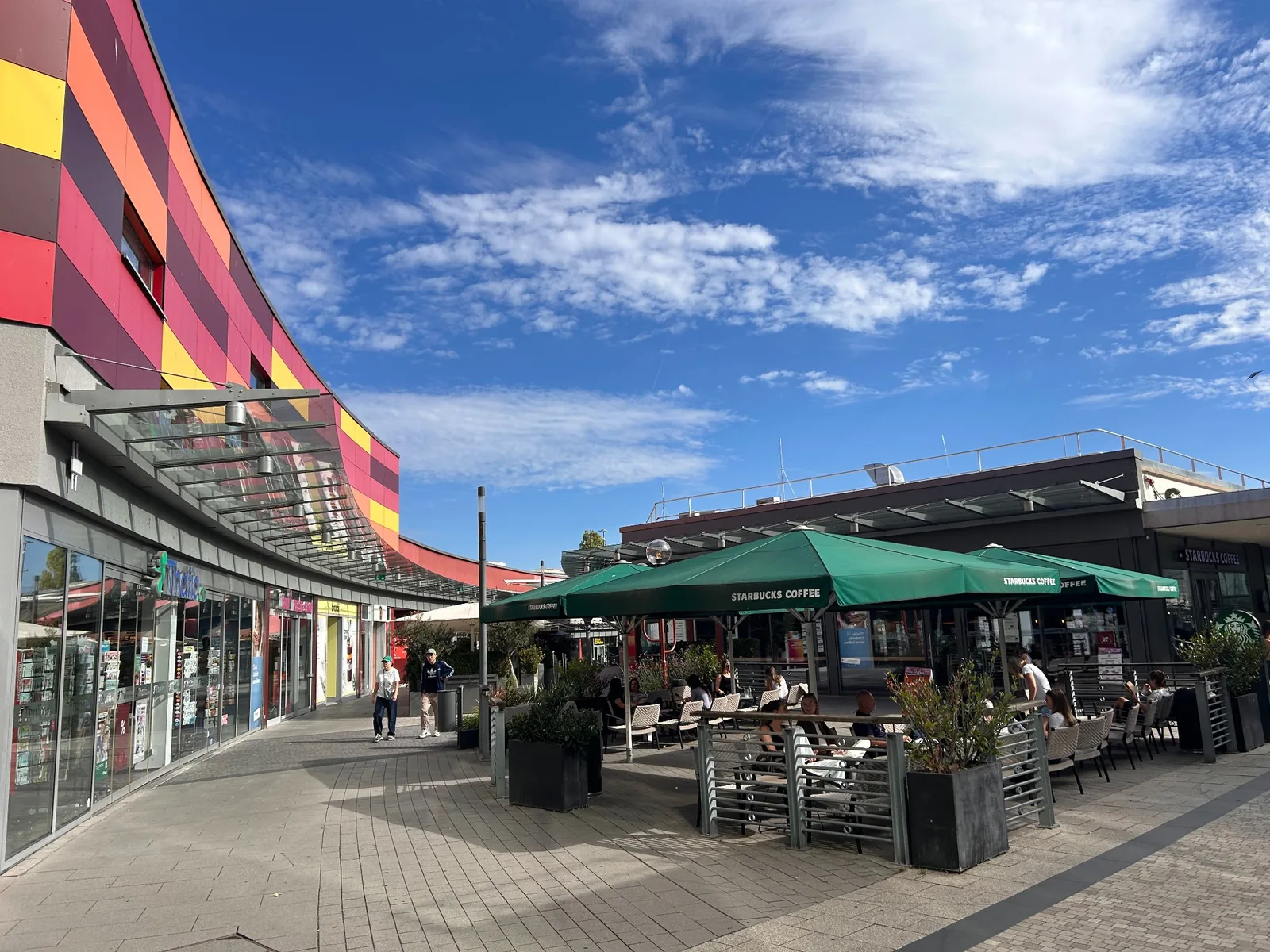 Outdoor café seating beside the shopping walkway at Main-Taunus-Zentrum